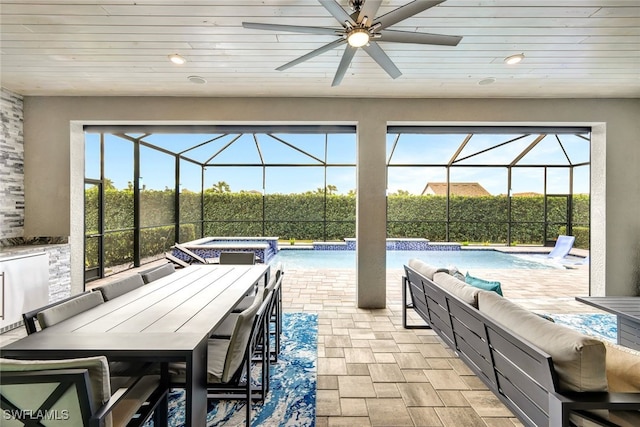 view of patio with a pool with hot tub, pool water feature, ceiling fan, and glass enclosure