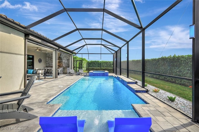 view of pool featuring an in ground hot tub, ceiling fan, a patio, and glass enclosure