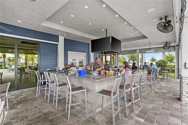 view of patio / terrace featuring ceiling fan and a bar