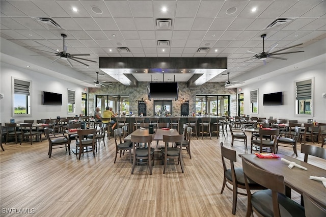 dining room with ceiling fan and a drop ceiling