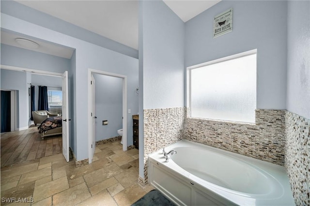 bathroom featuring a bathtub and toilet