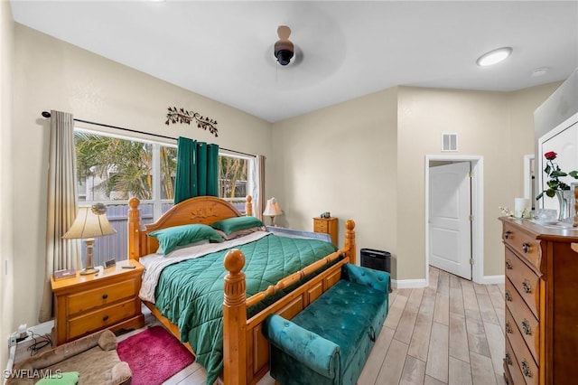 bedroom with ceiling fan and light hardwood / wood-style flooring