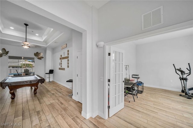 rec room featuring crown molding, light hardwood / wood-style flooring, a raised ceiling, and billiards