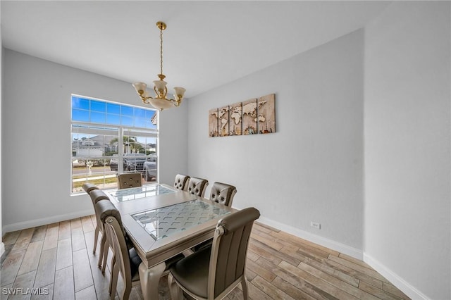 dining area featuring an inviting chandelier and light hardwood / wood-style floors