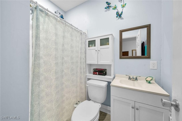 bathroom featuring toilet and vanity