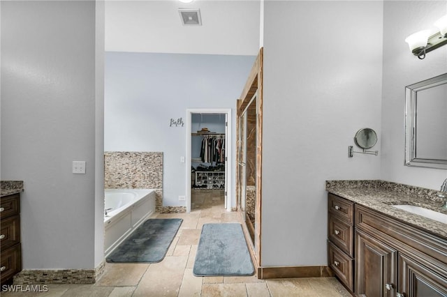 bathroom featuring plus walk in shower and vanity