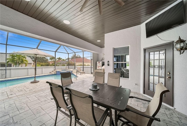 view of patio featuring a lanai, a pool with hot tub, and ceiling fan