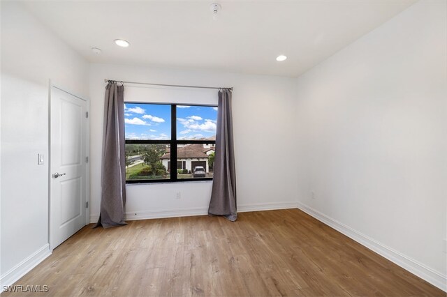 empty room with light hardwood / wood-style flooring