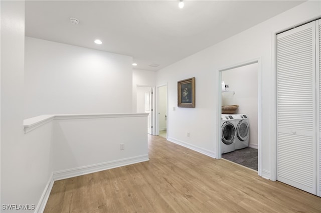 washroom featuring independent washer and dryer and light hardwood / wood-style floors