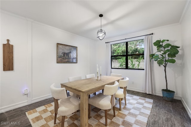 dining area with dark wood-type flooring and ornamental molding