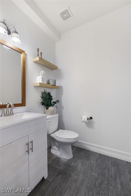 bathroom featuring toilet and vanity