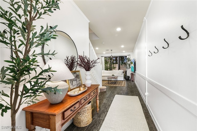 hallway featuring dark hardwood / wood-style flooring and crown molding