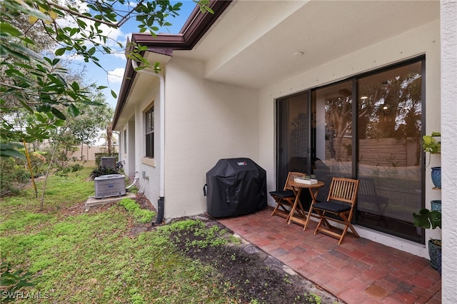 view of patio / terrace with cooling unit and a grill