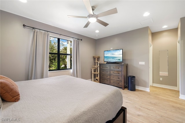 bedroom with ceiling fan and light hardwood / wood-style floors