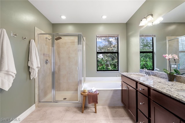 bathroom featuring independent shower and bath, tile patterned floors, and vanity