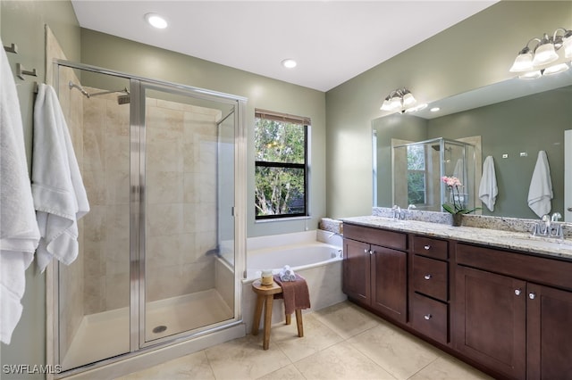 bathroom with tile patterned flooring, vanity, and shower with separate bathtub