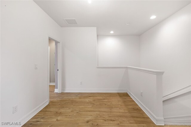 empty room with light hardwood / wood-style flooring