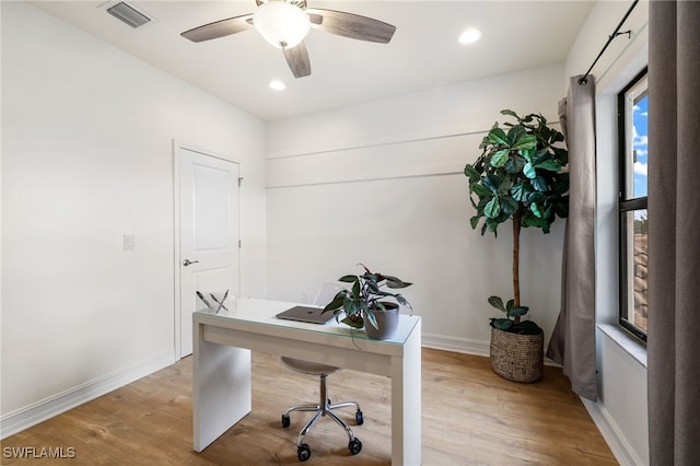 home office with ceiling fan and light hardwood / wood-style flooring