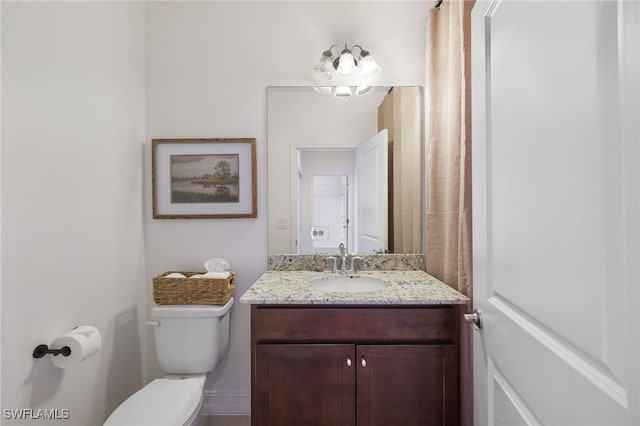 bathroom with toilet and vanity