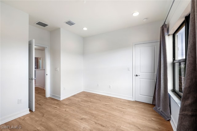 unfurnished room with light wood-type flooring