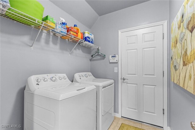 laundry room featuring light tile patterned floors and washer and dryer