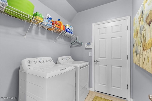 clothes washing area featuring laundry area, light tile patterned floors, baseboards, and independent washer and dryer