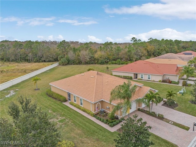 birds eye view of property with a view of trees