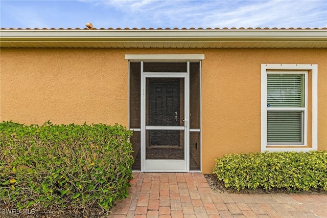 property entrance with a patio area