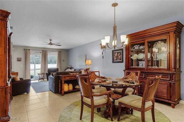 dining space with light tile patterned floors, ceiling fan with notable chandelier, and visible vents