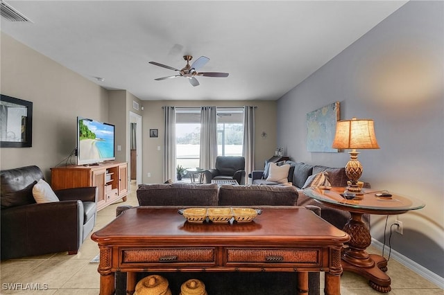 living area featuring visible vents, ceiling fan, baseboards, and light tile patterned flooring