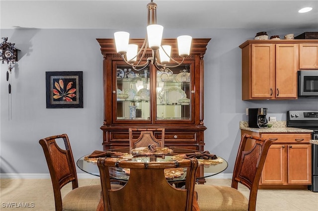 dining space with light tile patterned floors and an inviting chandelier