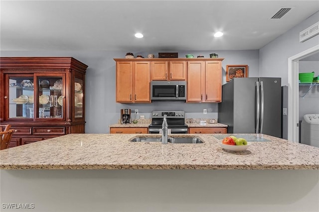 kitchen with light stone countertops, visible vents, appliances with stainless steel finishes, and recessed lighting