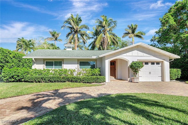 ranch-style house with a front yard and a garage