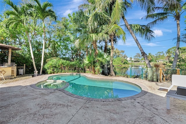 view of pool with a water view and a patio