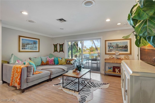 living room with ornamental molding and light hardwood / wood-style floors