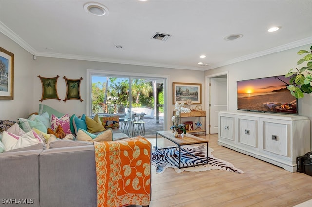 living room with light hardwood / wood-style floors and crown molding