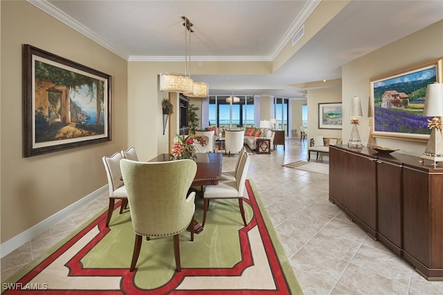 dining room featuring crown molding