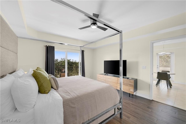 bedroom with dark wood-type flooring, ceiling fan, and access to outside