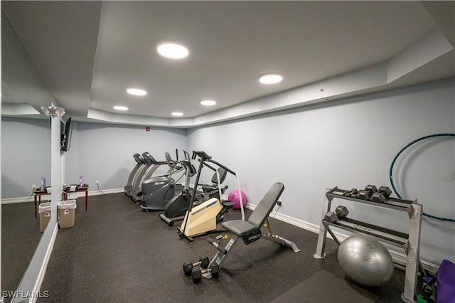 gym with a tray ceiling