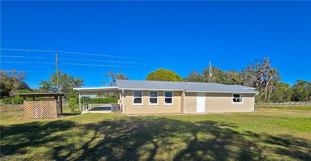 view of outdoor structure featuring a lawn and central air condition unit