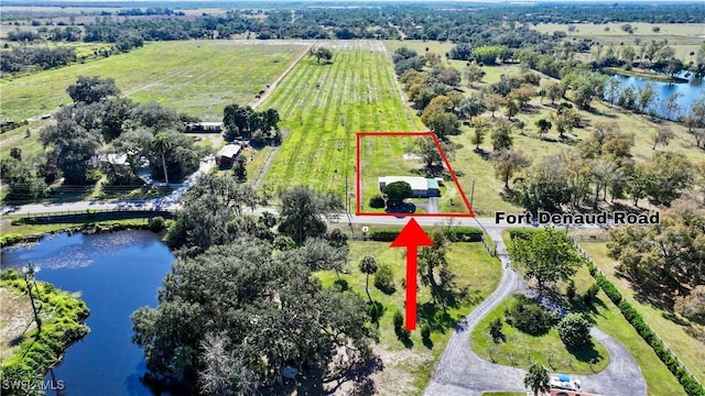 birds eye view of property with a rural view and a water view