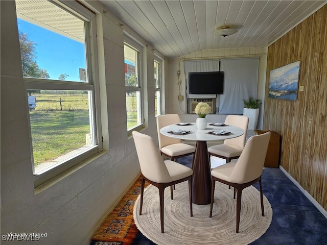 sunroom / solarium with wooden ceiling, a wealth of natural light, and vaulted ceiling