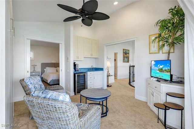 living room featuring vaulted ceiling, ceiling fan, light carpet, and wine cooler