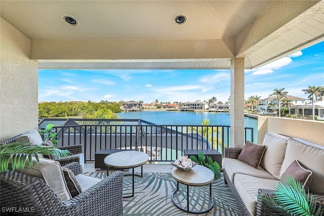 balcony with outdoor lounge area and a water view