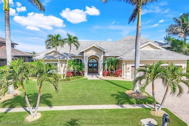 view of front of house with a front yard and french doors