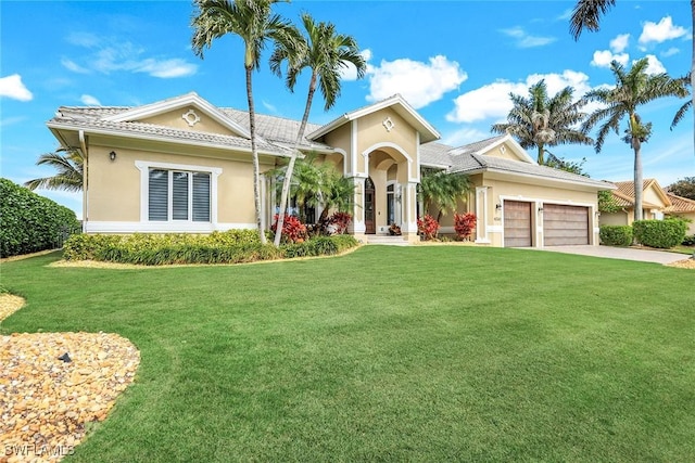 view of front of home featuring a front yard and a garage