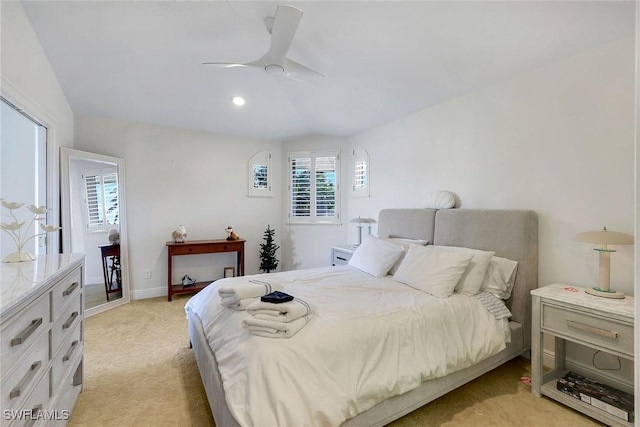 bedroom featuring ceiling fan, light colored carpet, and lofted ceiling