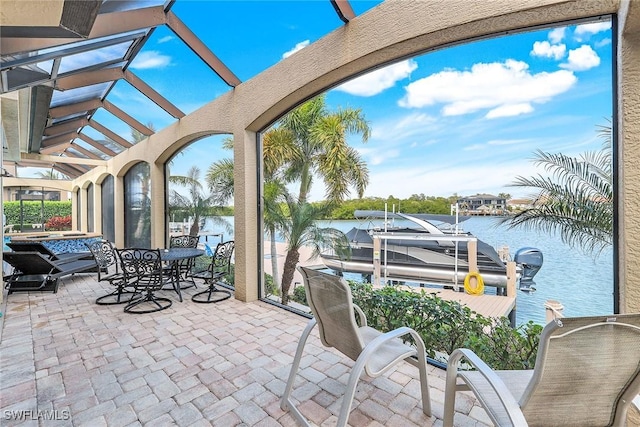 exterior space with a water view, a hot tub, and a dock