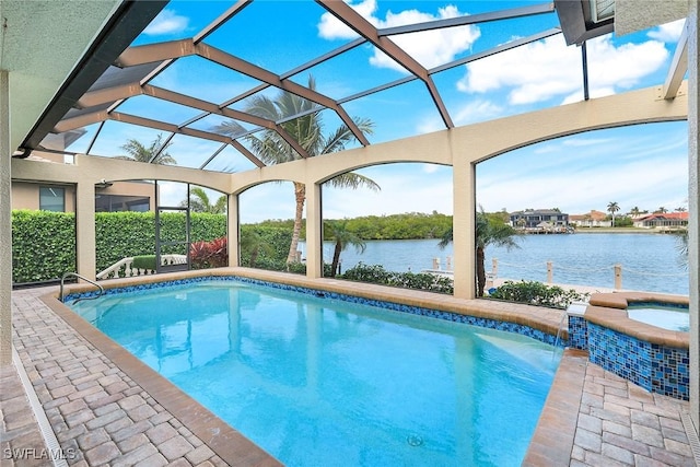 view of swimming pool with a lanai, pool water feature, and a water view