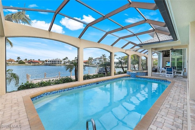 view of swimming pool with glass enclosure, a water view, an in ground hot tub, and a patio